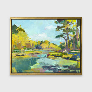 A chartreuse, light blue and green abstract landscape print in a gold floater frame hangs on a white wall.