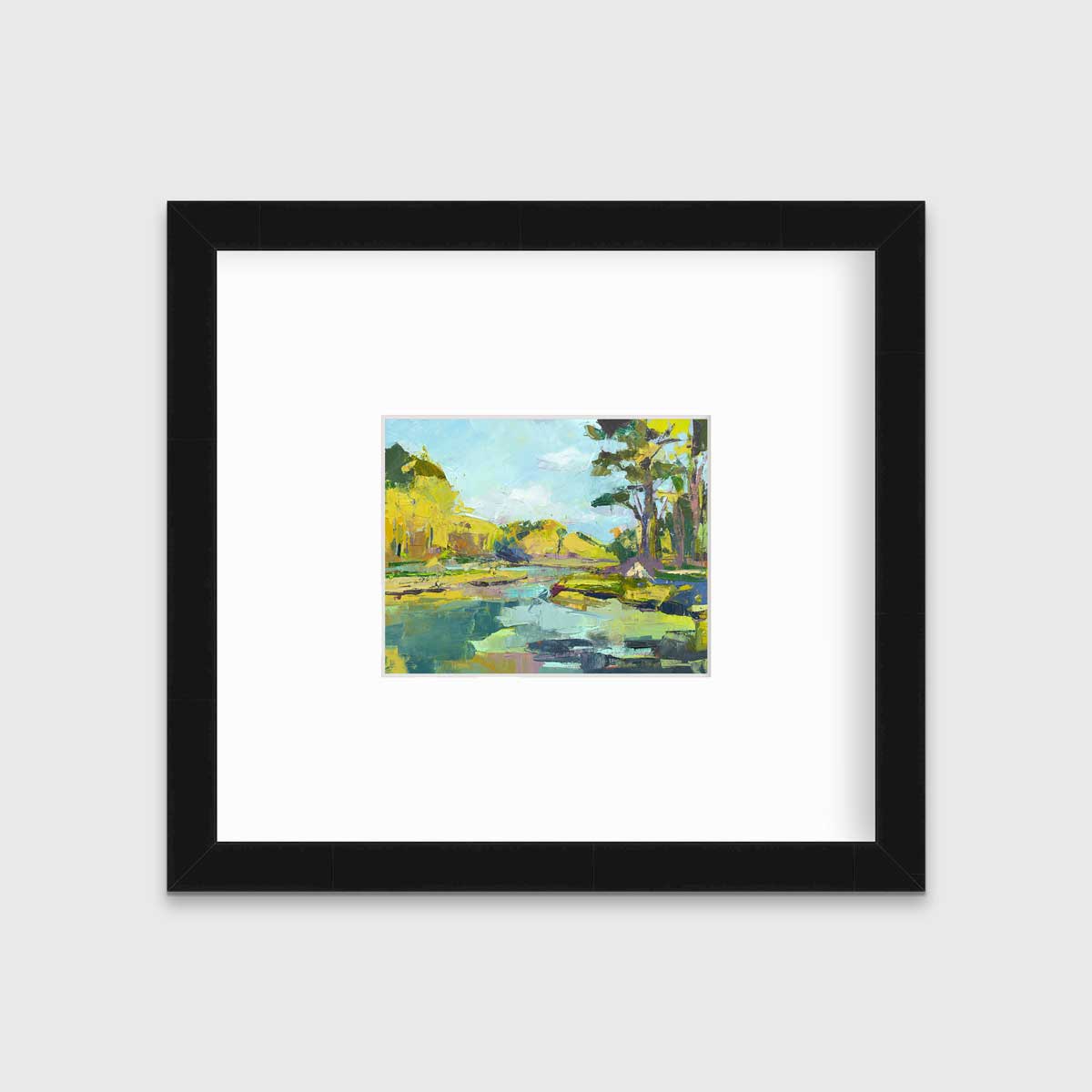 A chartreuse, light blue and green abstract landscape print in a black frame with a mat hangs on a white wall.