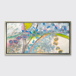 A multicolored abstract print in a silver floater frame hangs on a white wall.