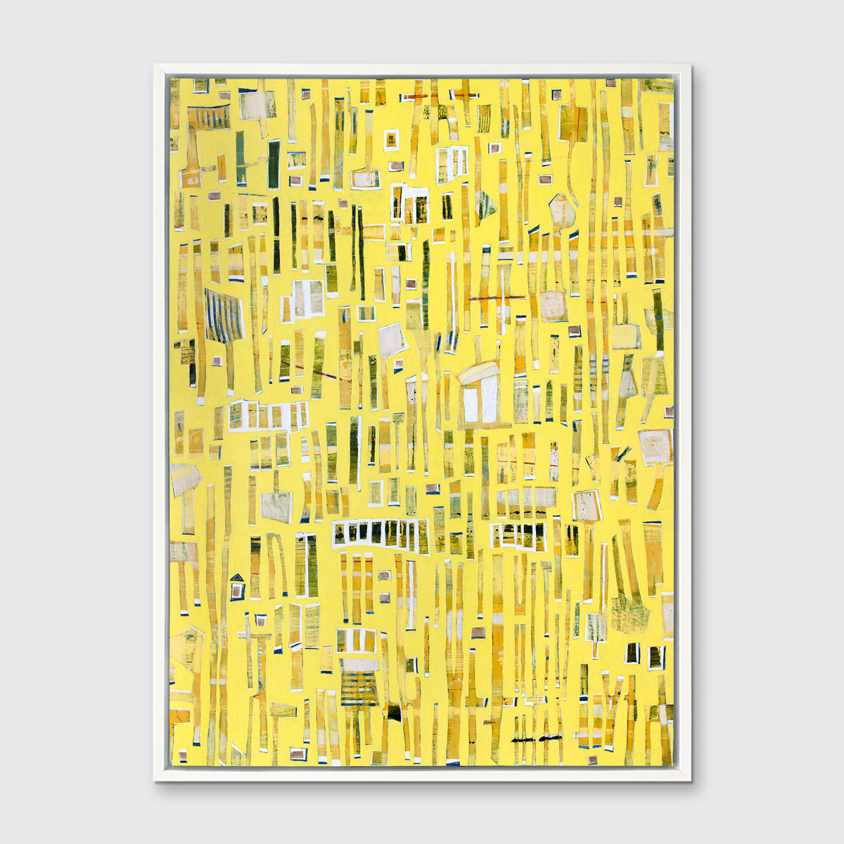 A yellow, white and black abstract print in a white floater frame hangs on a white wall.