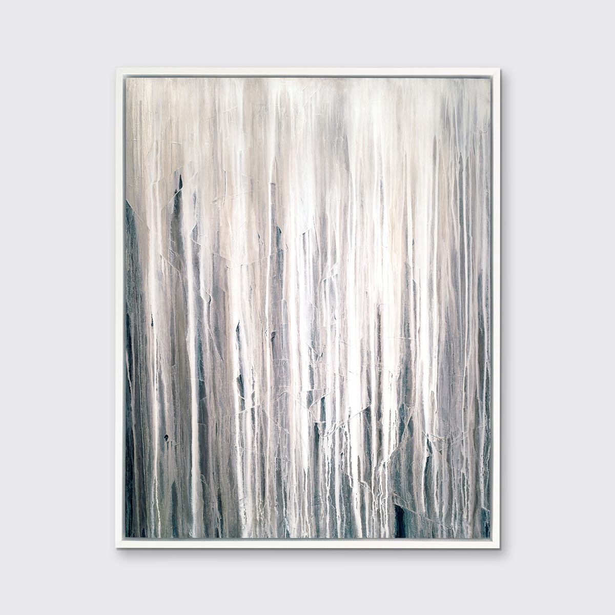 A white, cream and charcoal print in a white floater frame hangs on a white wall.