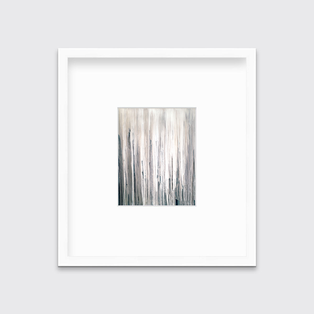 A white, cream and charcoal print in a white frame with a mat hangs on a white wall.