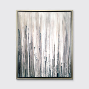 A white, cream and charcoal print in a silver floater frame hangs on a white wall.