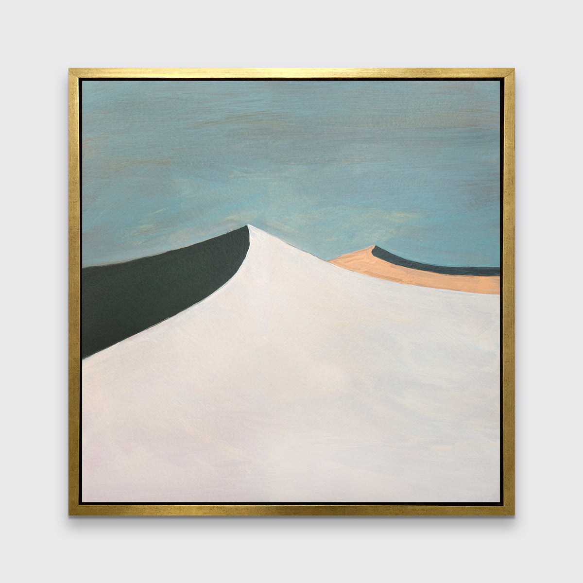 A blue, white, peach and dark teal abstract landscape print in a gold floater frame hangs on a white wall.