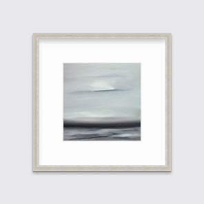 A tonal grey and black print in a silver frame with a mat hangs on a white wall.