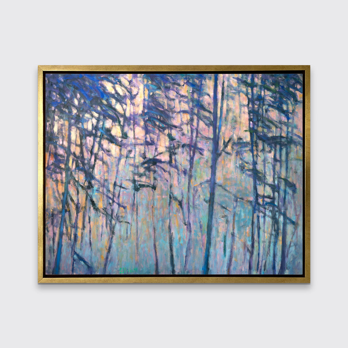A multicolored abstract tree landscape print in a gold floater frame hangs on a white wall.