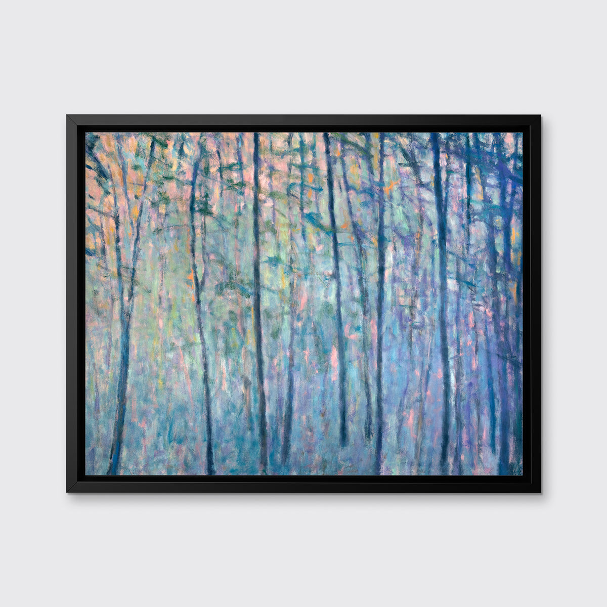 A multicolored abstract tree landscape print in a black floater frame hangs on a white wall.