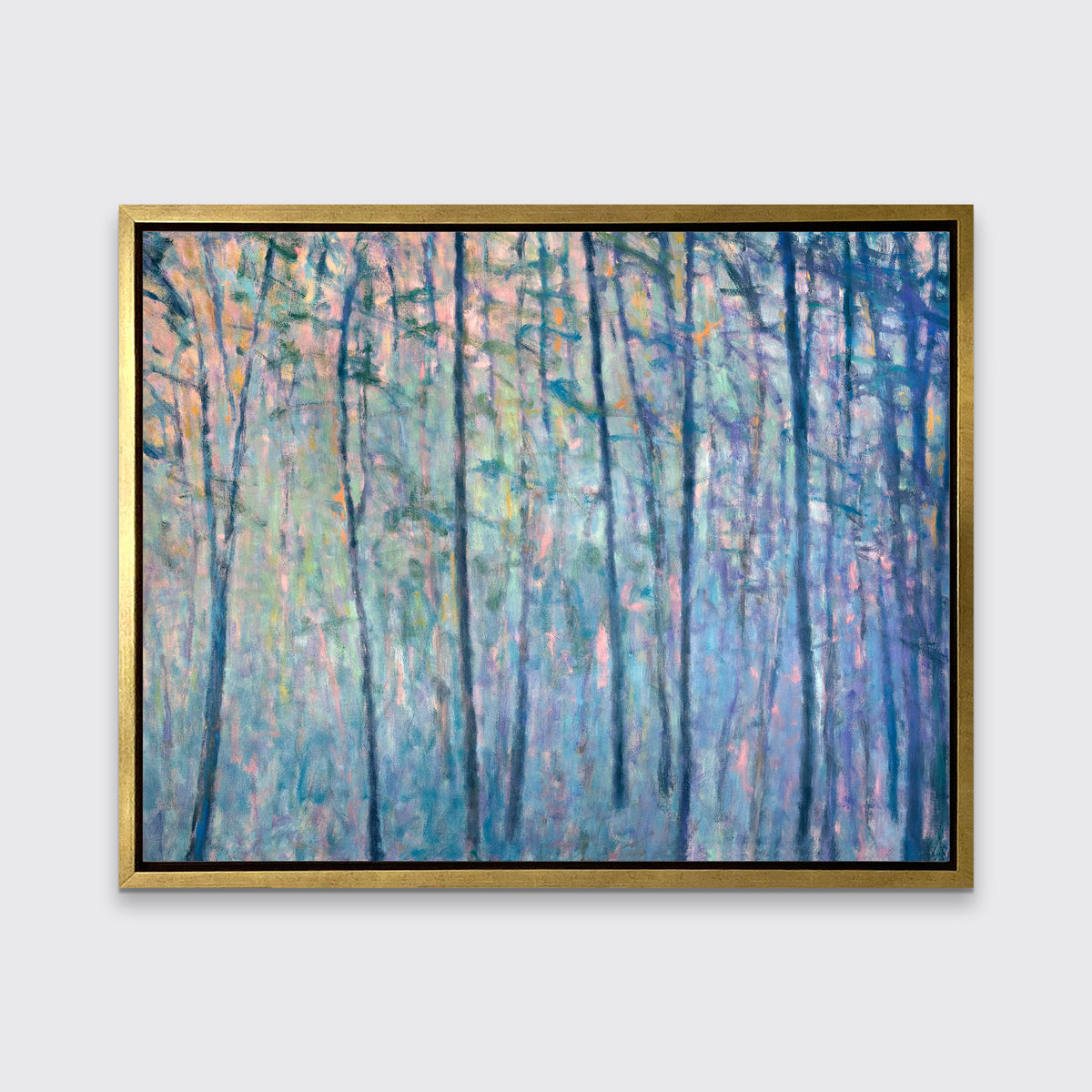 A multicolored abstract tree landscape print in a gold floater frame hangs on a white wall.