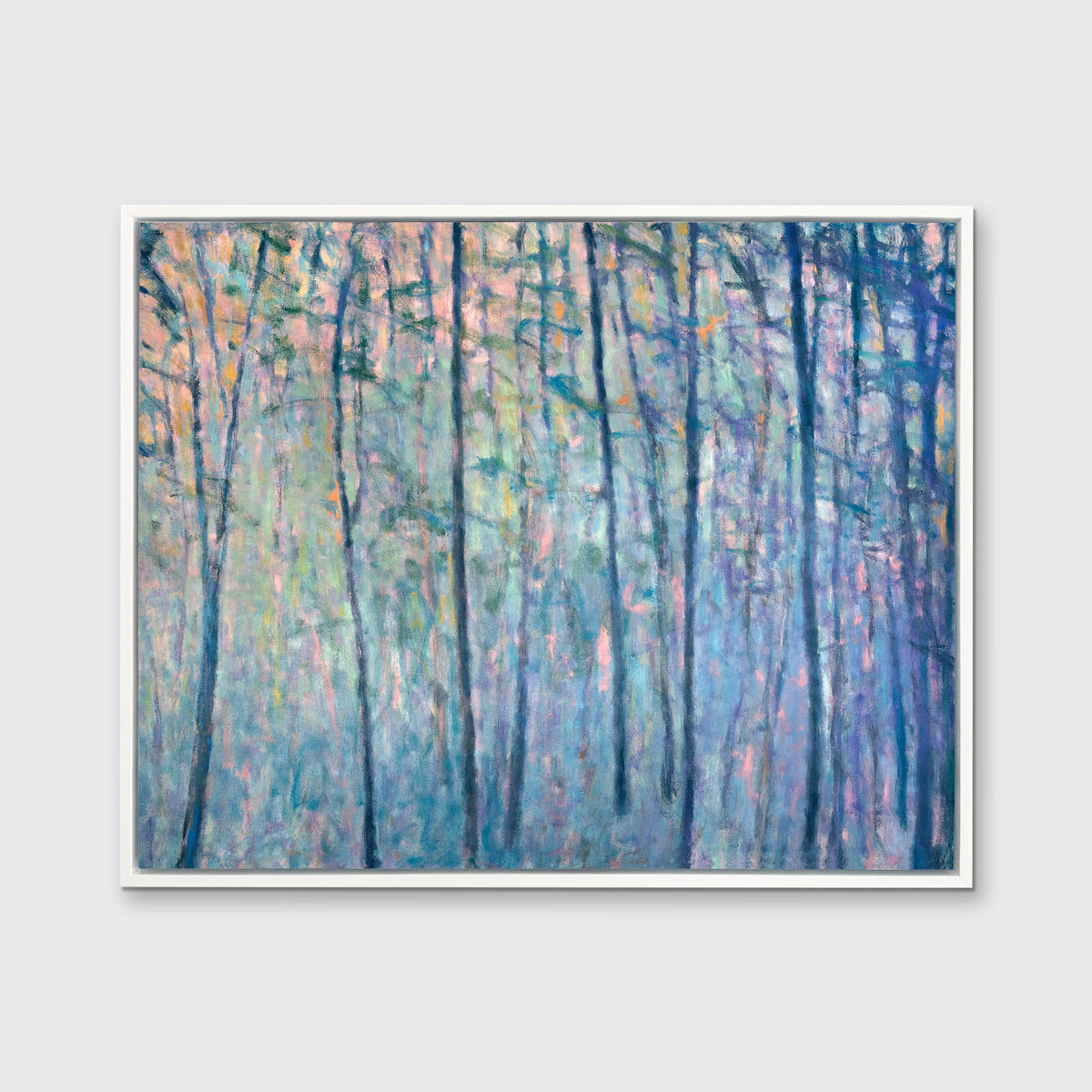 A multicolored abstract tree landscape print in a white floater frame hangs on a white wall.