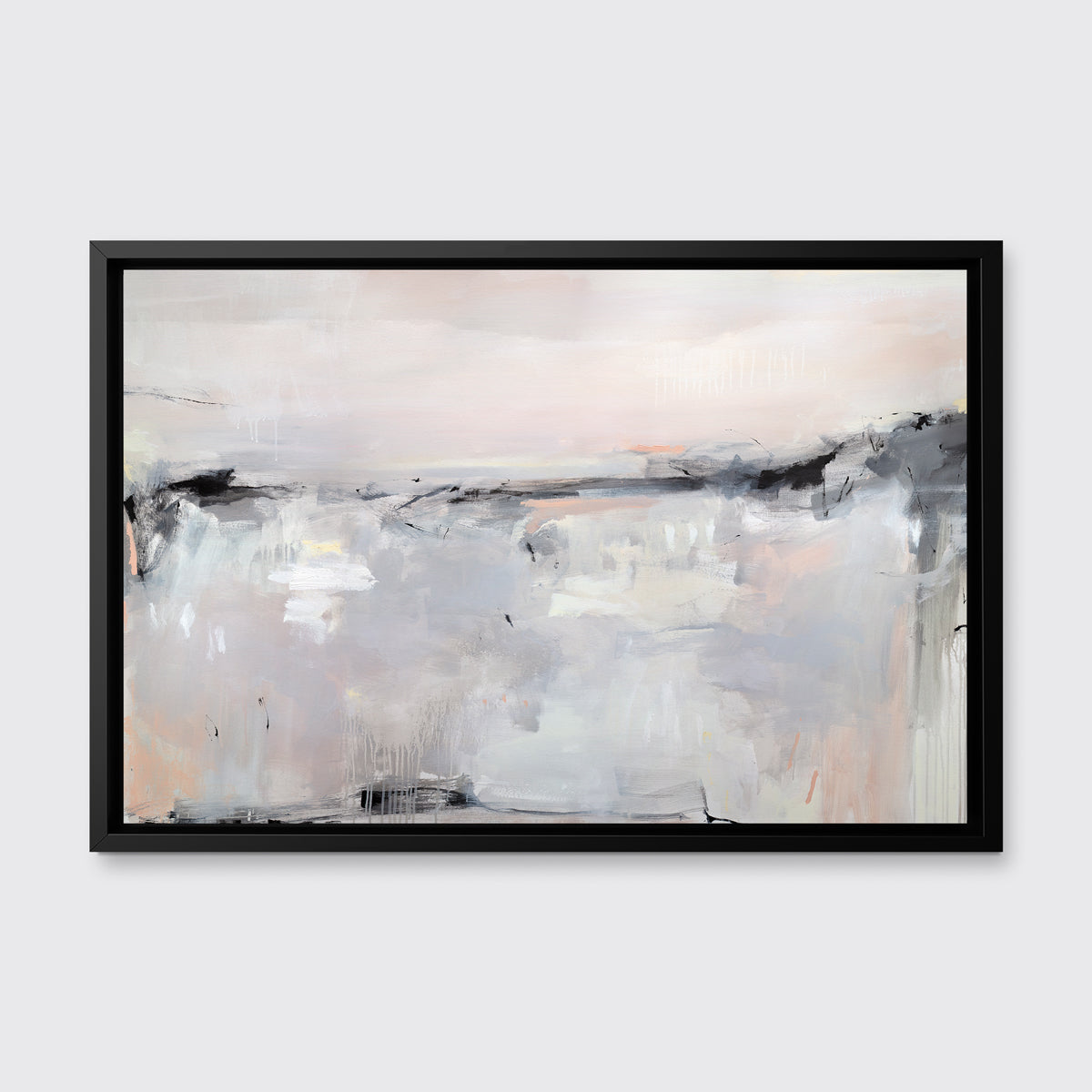 A light pink, black, grey and white abstract print in a black floater frame hangs on a white wall.