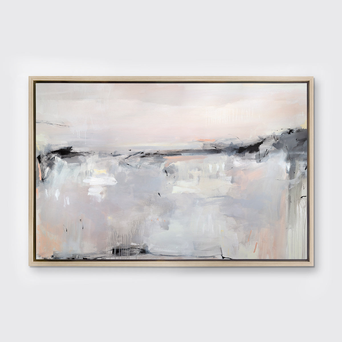 A light pink, black, grey and white abstract print in a white oak wood floater frame hangs on a white wall.