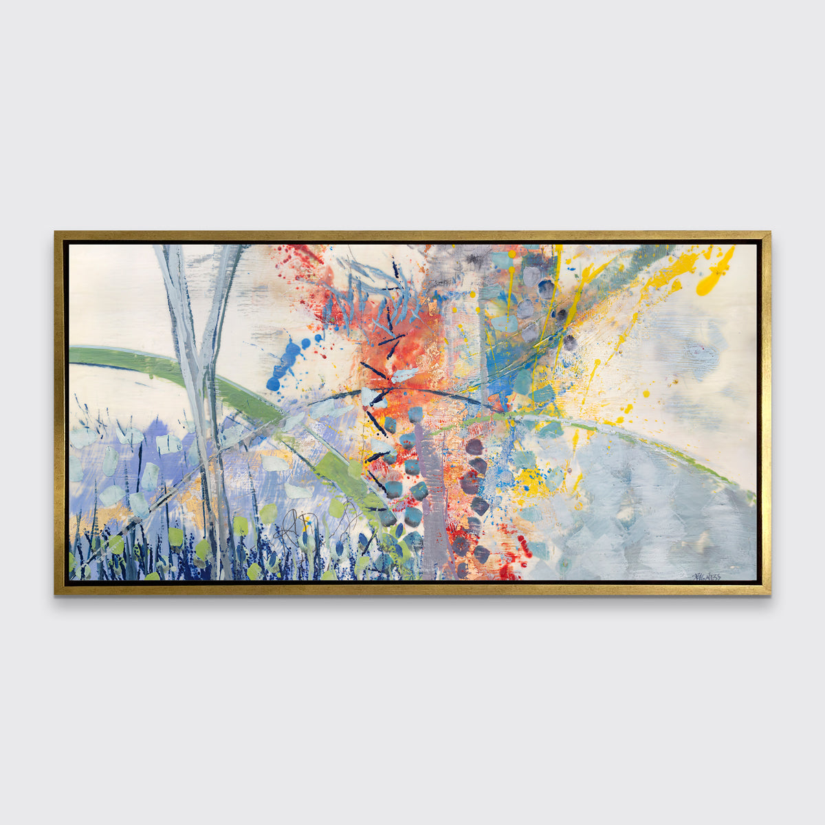 A multicolored abstract print in a gold floater frame hangs on a white wall.