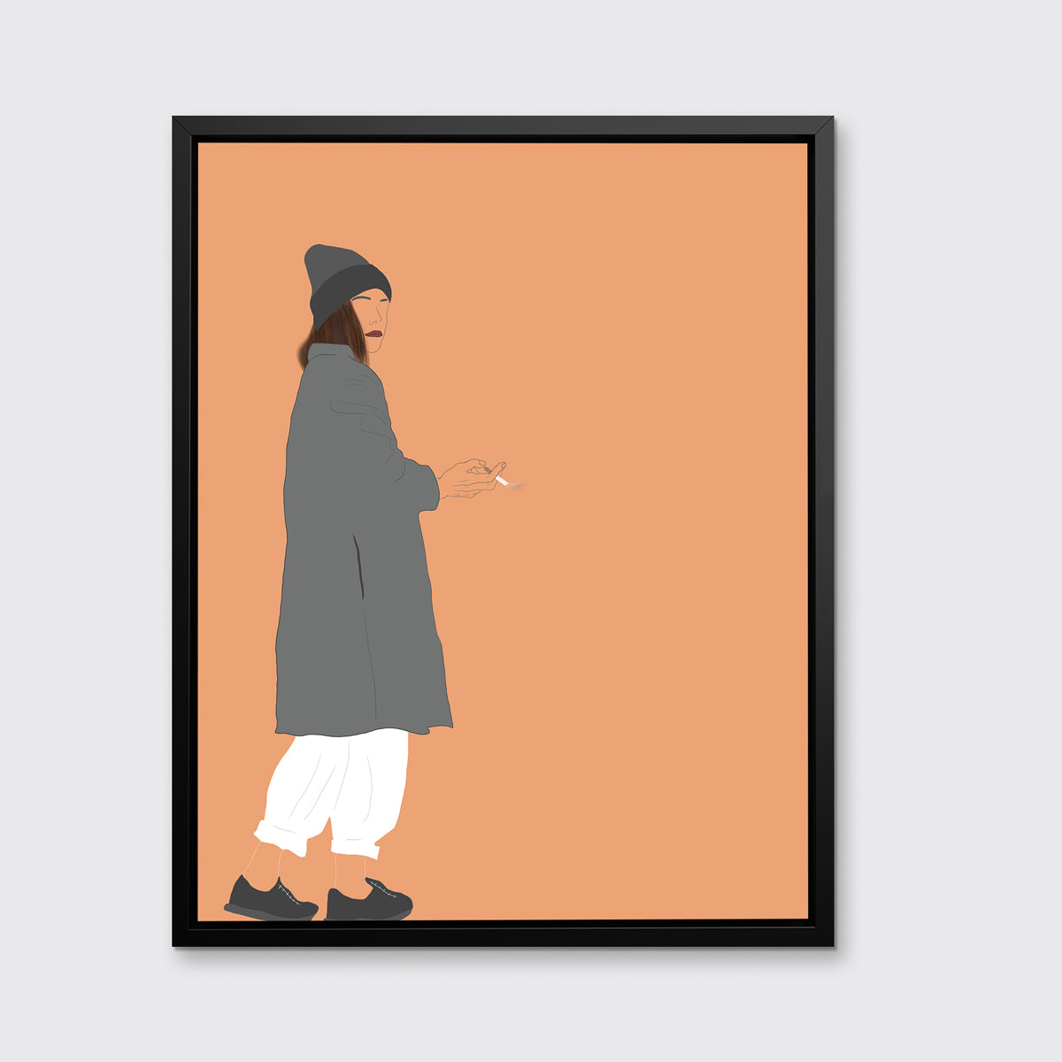 Art print of an illustrated woman wearing grey hat and coat, white pants, and grey sneakers, holding a cigarette, framed in a black floater frame on a grey wall.
