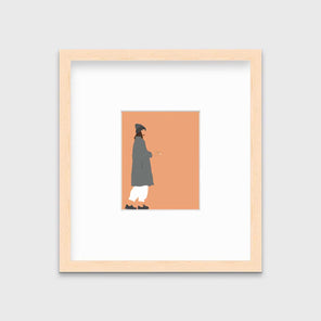 Art print of an illustrated woman wearing grey hat and coat, white pants, and grey sneakers, holding a cigarette with orange background, framed in a natural wood frame on a grey wall.