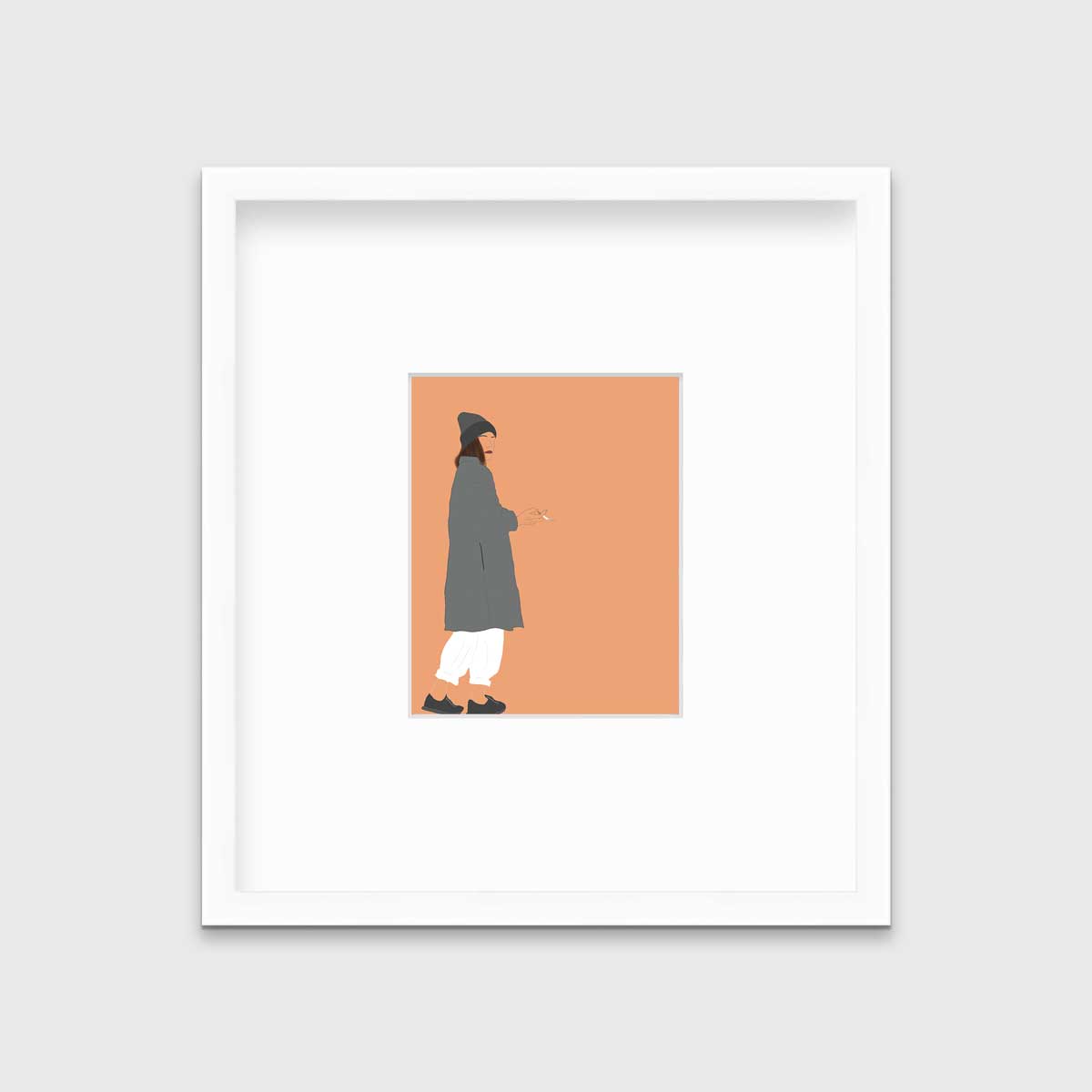 Art print of an illustrated woman wearing grey hat and coat, white pants, and grey sneakers, holding a cigarette with orange background, framed in a white mat and frame on a grey wall.