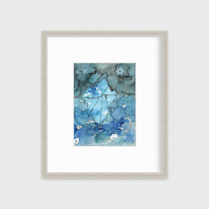 A blue abstract glacier illustration print in a silver frame with a mat hangs on a white wall.