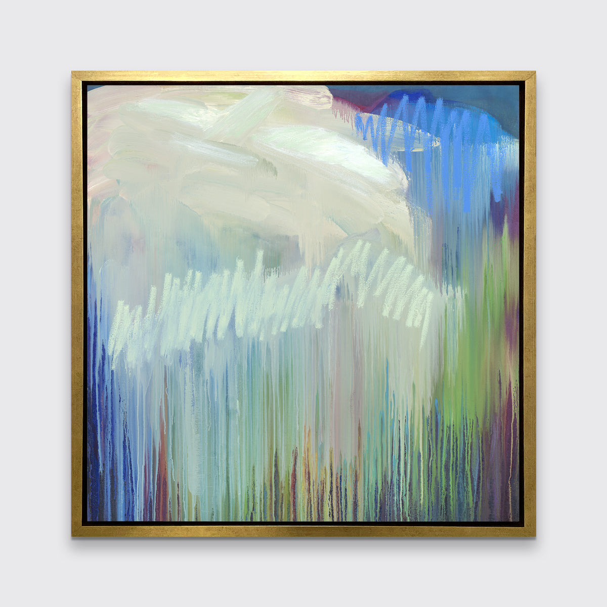 A multicolored abstract print in a gold floater frame hangs on a white wall.