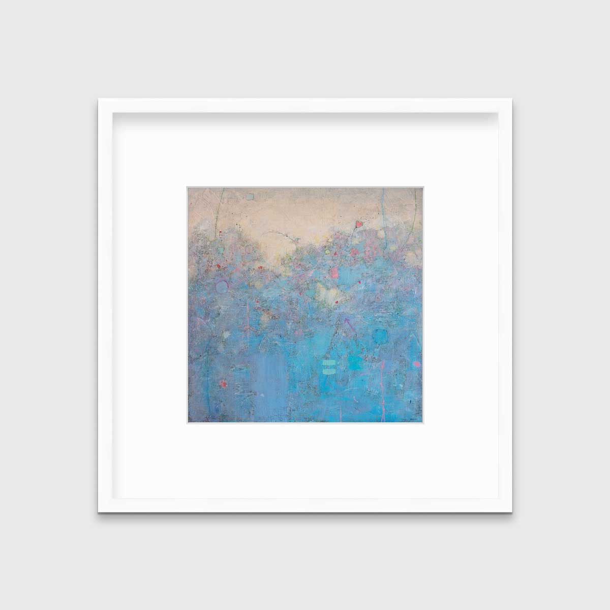 A blue abstract landscape print in a white frame with a mat hangs on a white wall.