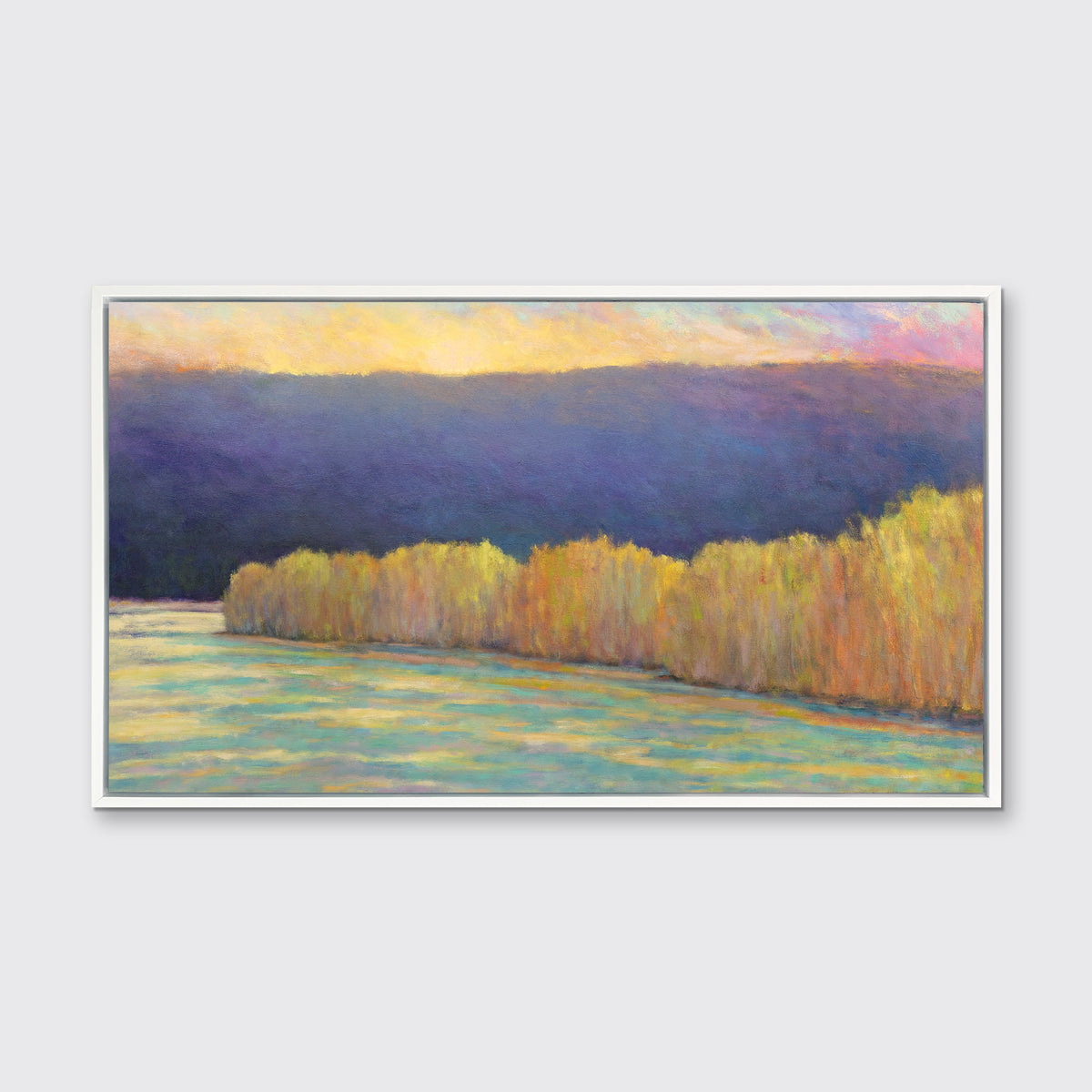 A purple, yellow, orange and blue abstract landscape print in a white floater frame hangs on a white wall.