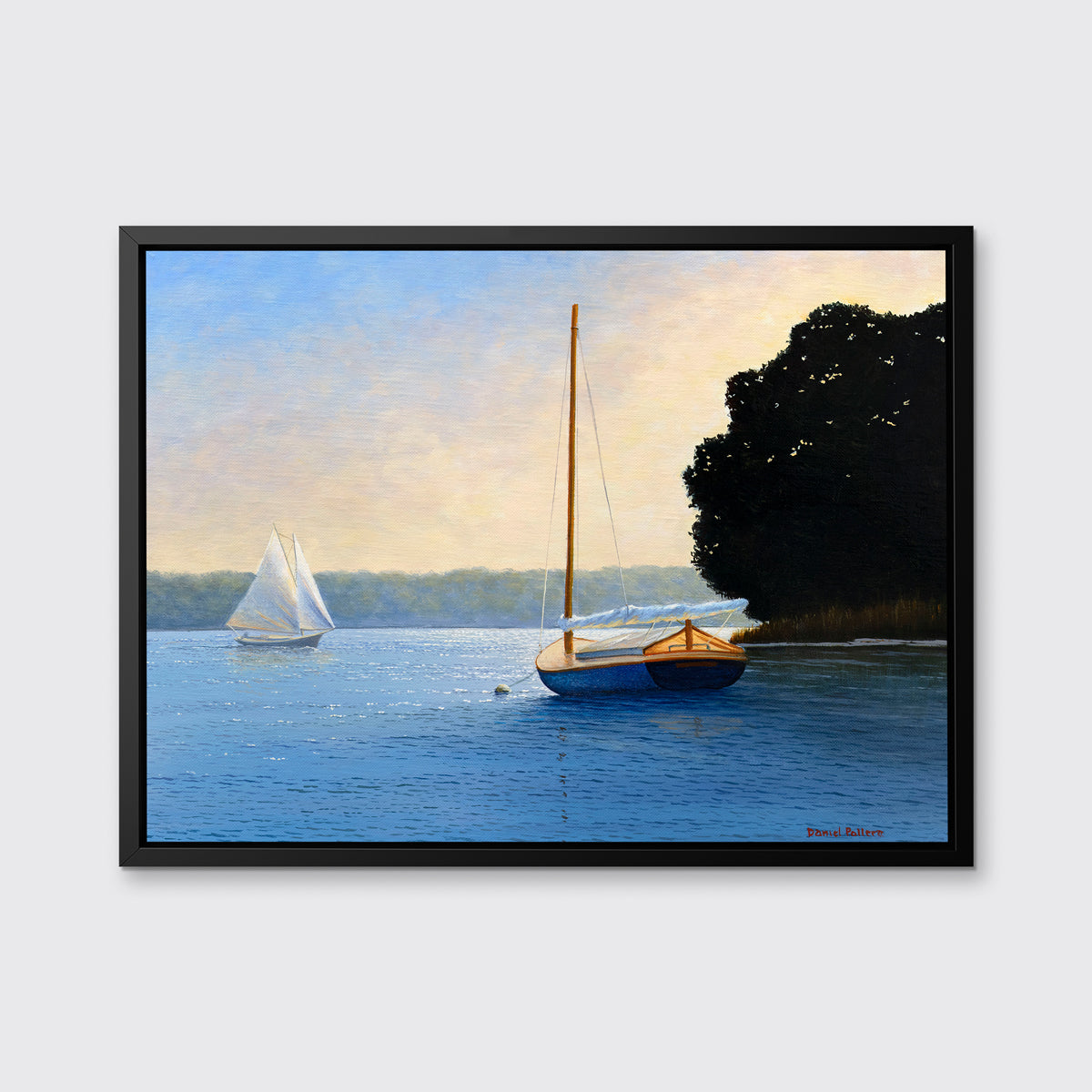 A blue, beige and black contemporary seascape print with two sailboats in a black floater frame hangs on a white wall.