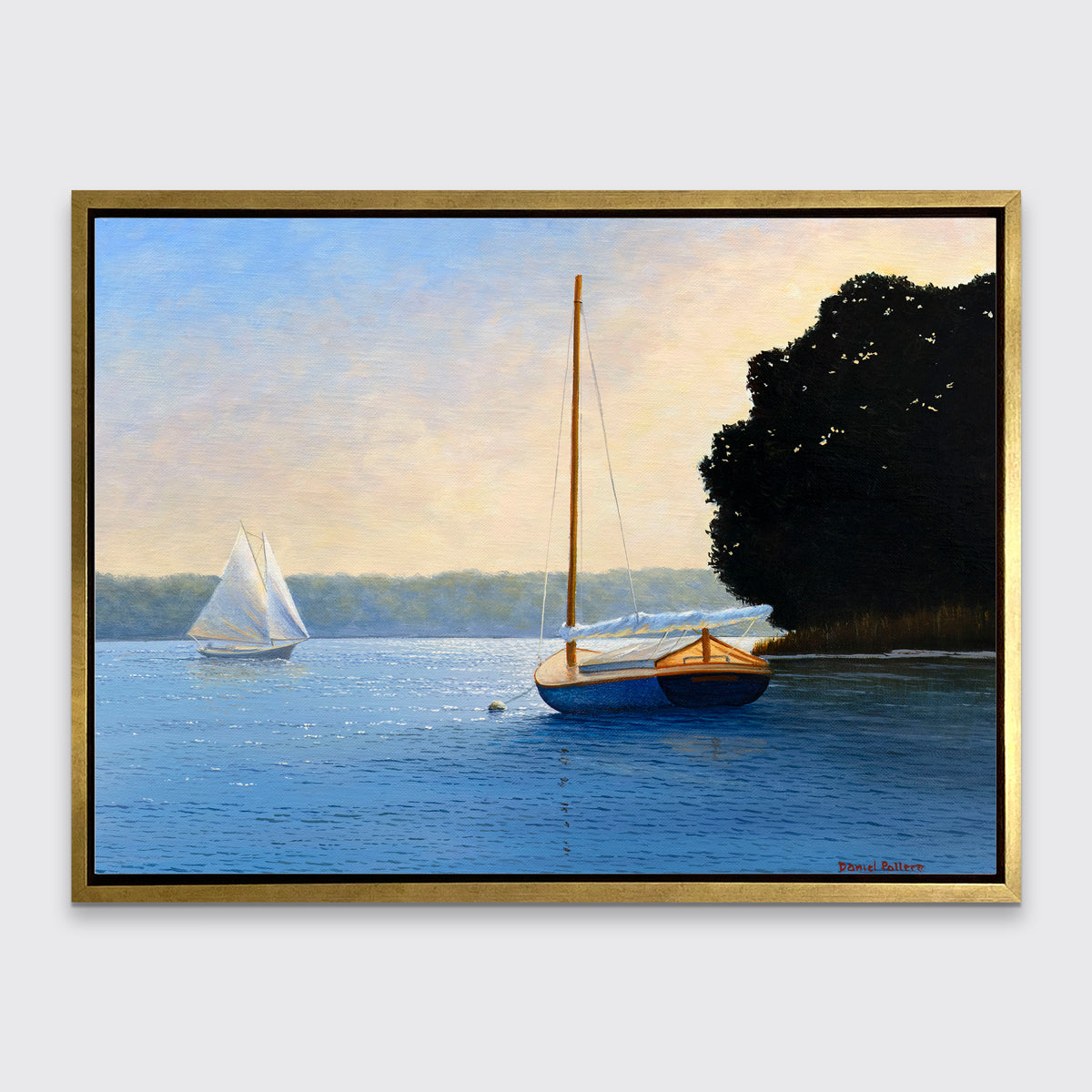 A blue, beige and black contemporary seascape print with two sailboats in a gold floater frame hangs on a white wall.