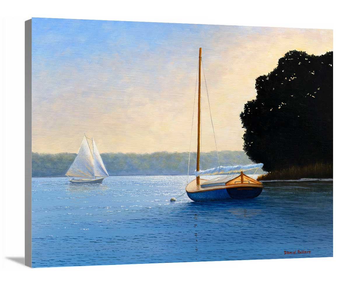 A side-angle view of a blue, beige and black contemporary seascape print with two sailboats on canvas.