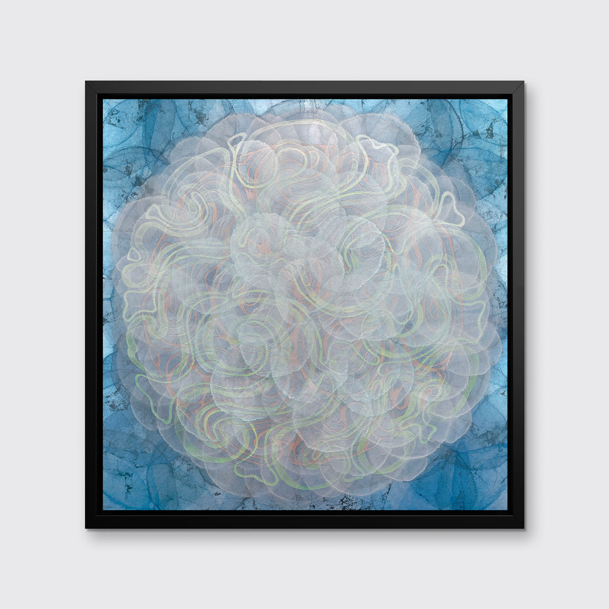 A blue, white, orange and yellow abstract geometric print in a black floater frame hangs on a white wall.
