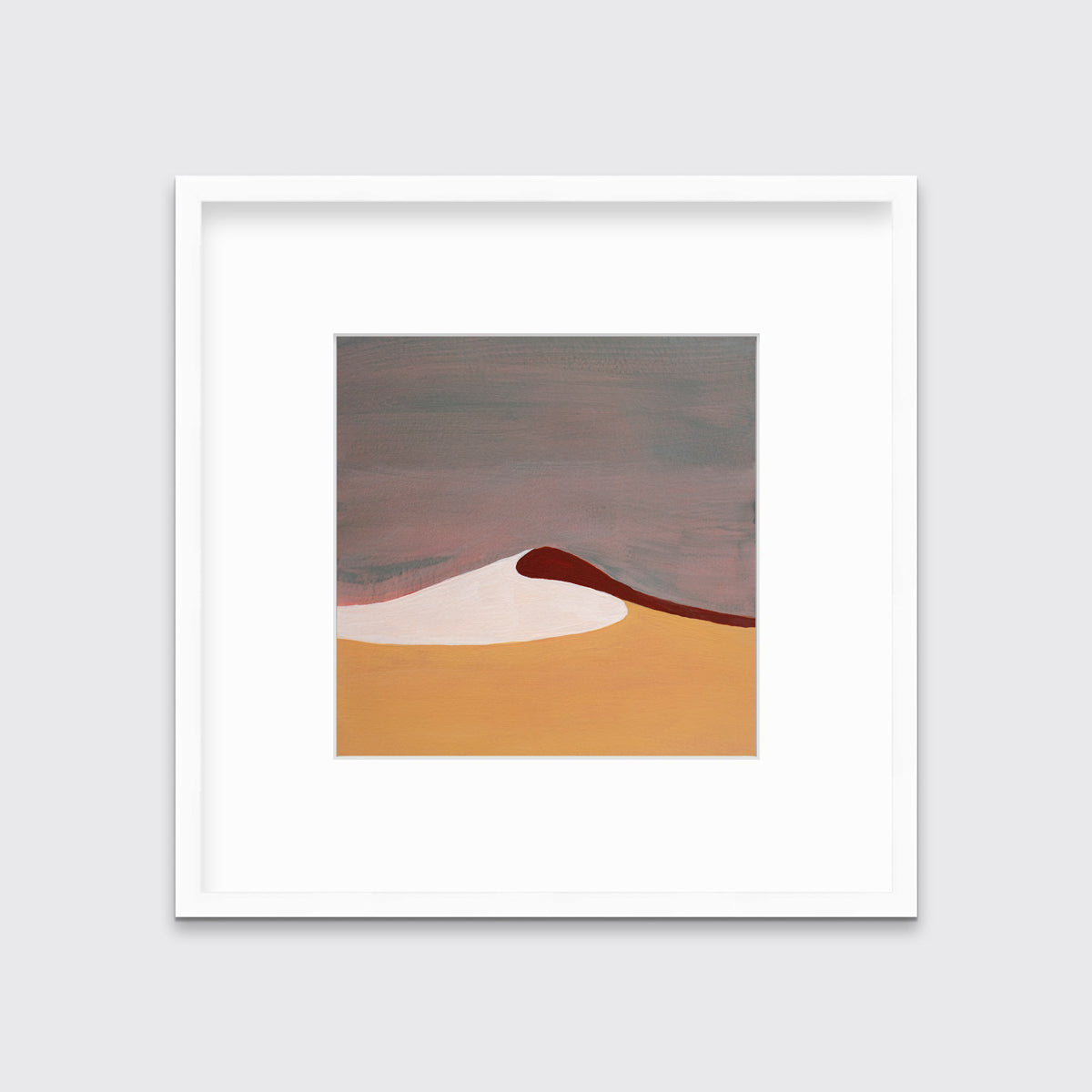 A mauve, burnt yellow, red and white abstract landscape print in a white frame with a mat hangs on a white wall.