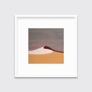 A mauve, burnt yellow, red and white abstract landscape print in a white frame with a mat hangs on a white wall.