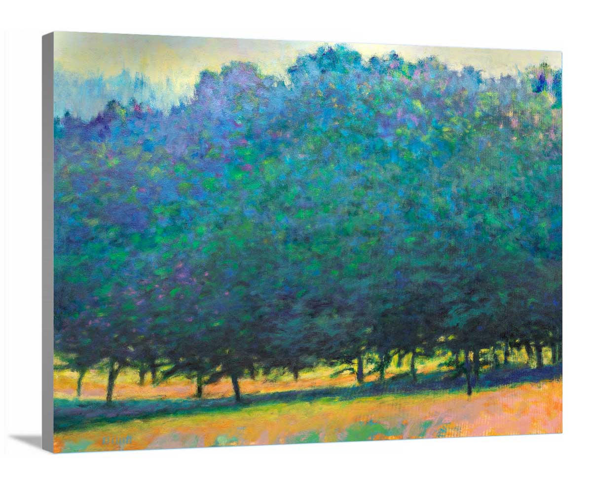 A side-angle view of a green, orange and teal abstract tree landscape print on canvas.