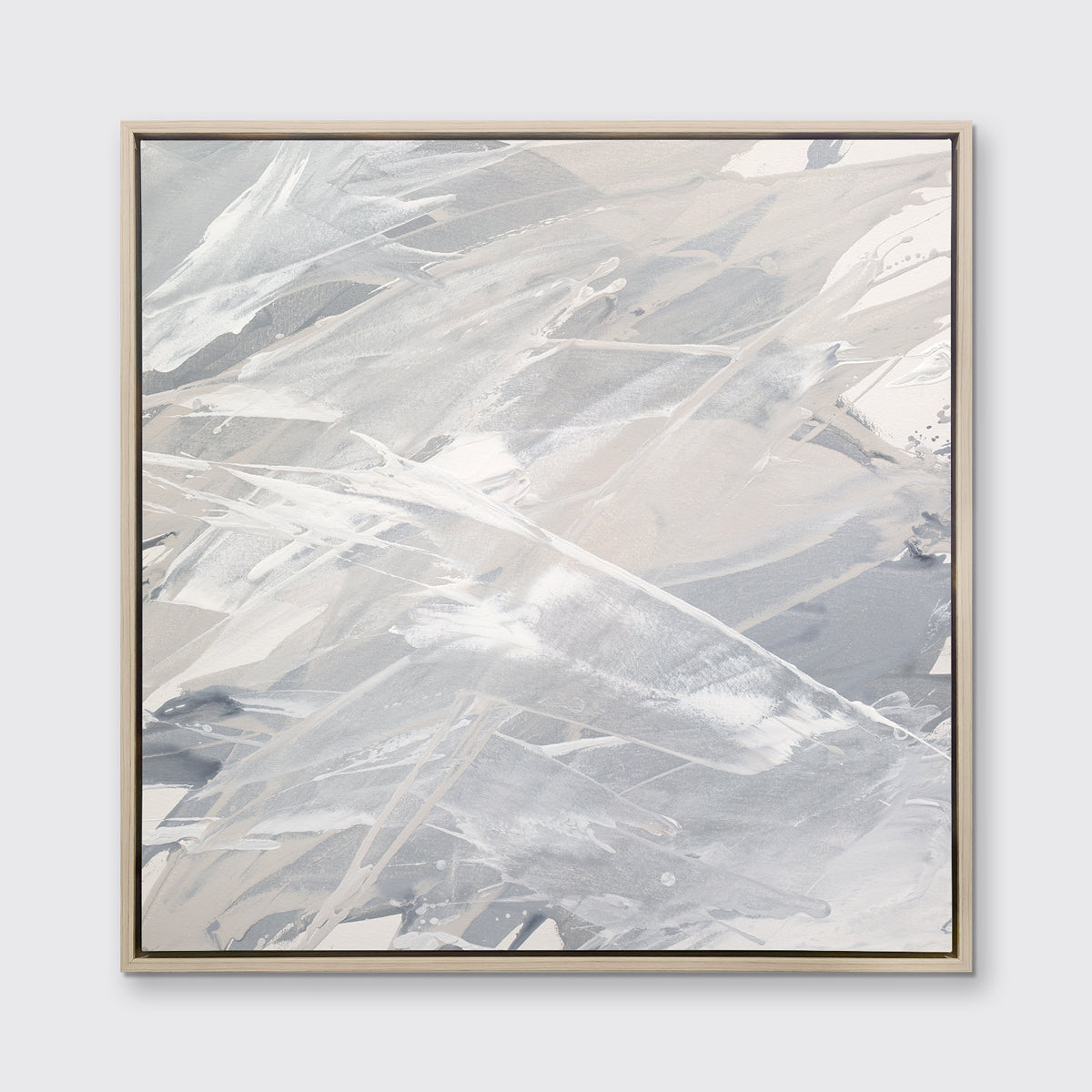 A grey, beige and white abstract print in a white oak wood floater frame hangs on a white wall.