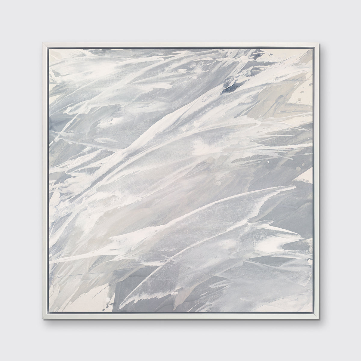 A grey, beige and white abstract print in a white floater frame hangs on a white wall.