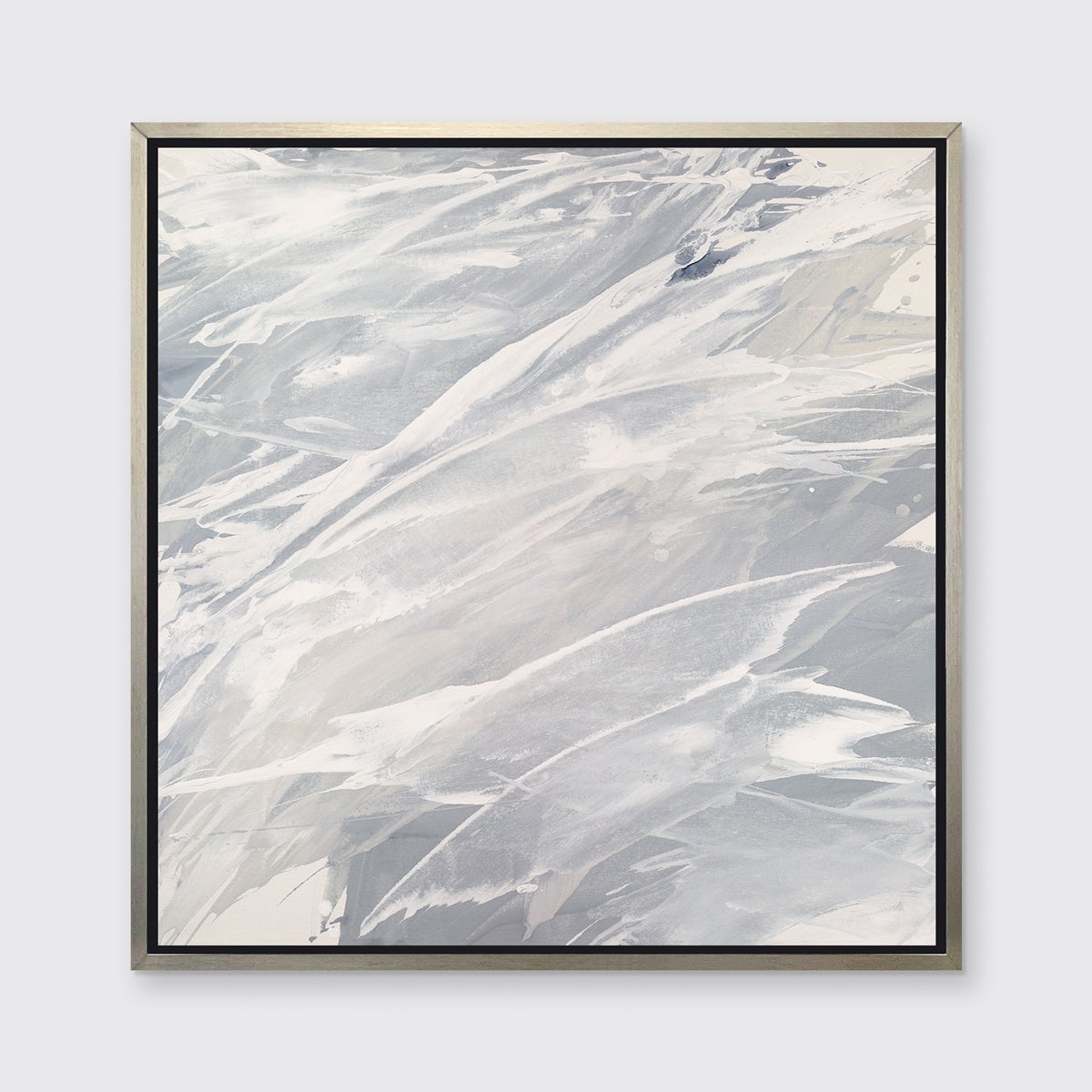 A grey, beige and white abstract print in a silver floater frame hangs on a white wall.