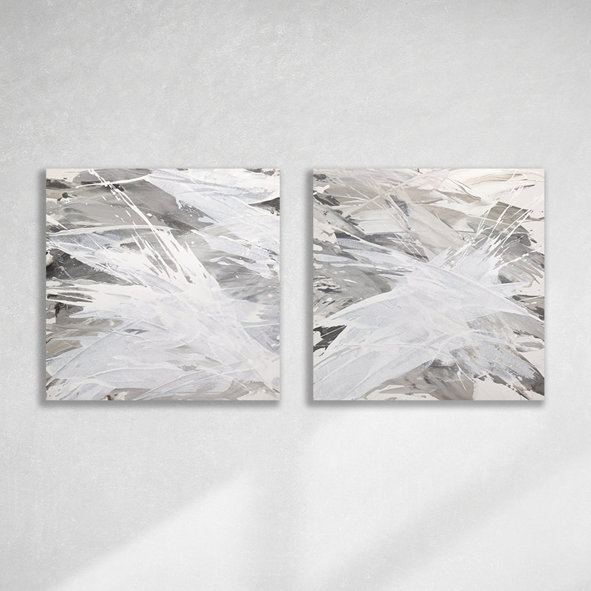 Two original paintings featuring abstract grey tones with a bird (owl) motif, displayed horizontally hanging on a wall.