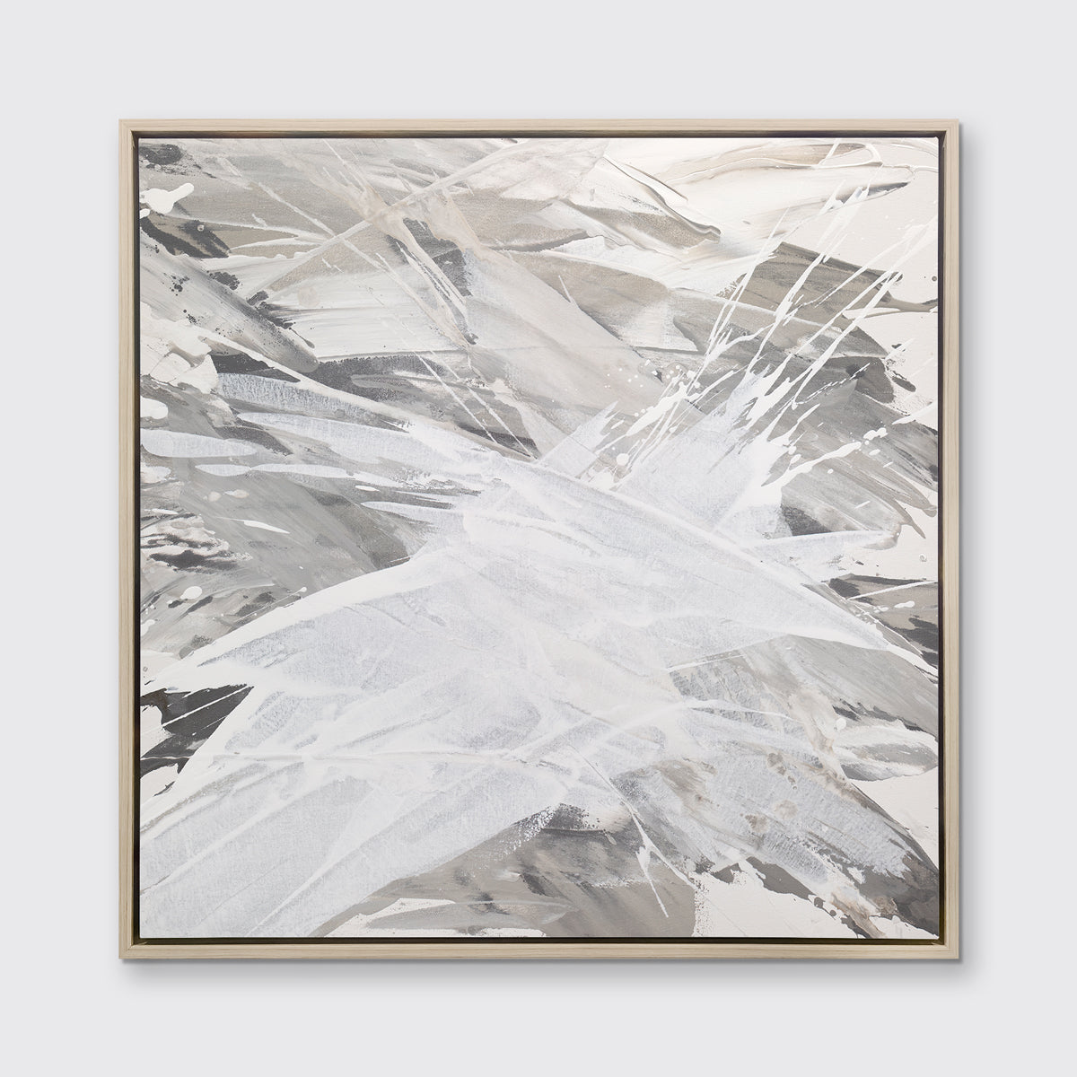A grey, beige and white abstract print in a white oak wood floater frame hangs on a white wall.
