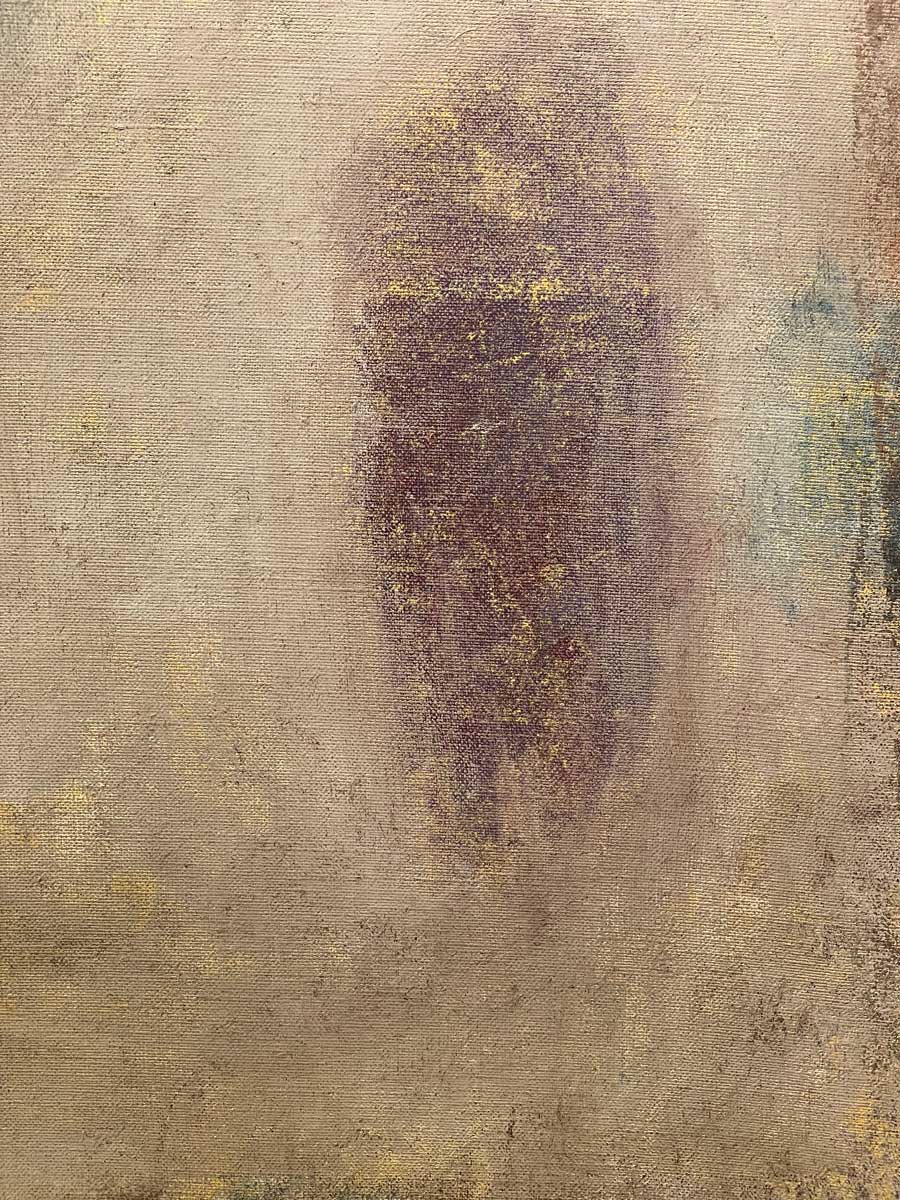 An up close detail of beige and muted purple paint with gold accents.