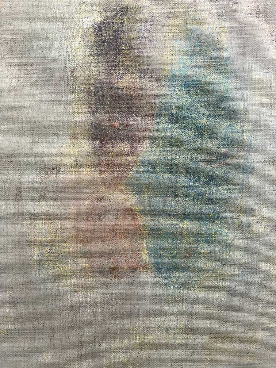 An up close detail of grey, muted purple and green paint with gold accents.
