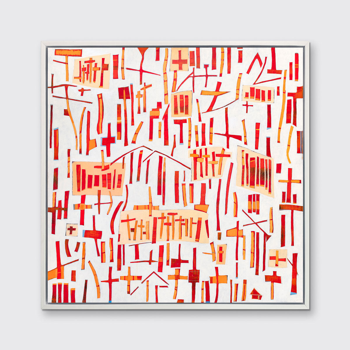 A red, orange and white abstract print in a white floater frame hangs on a white wall.