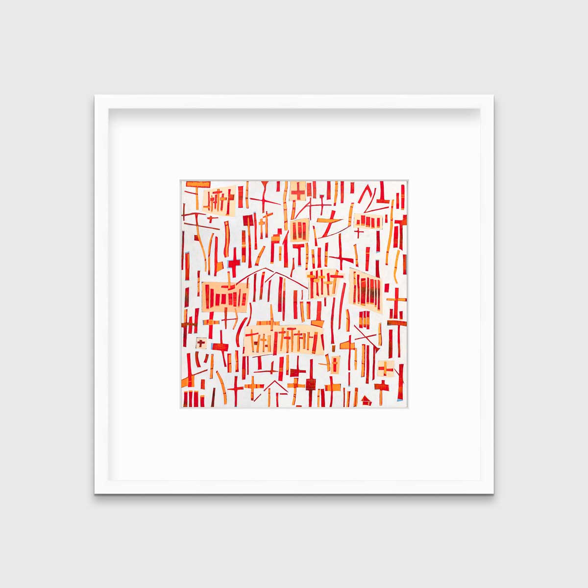 A red, orange and white abstract print in a white frame with a mat hangs on a white wall.