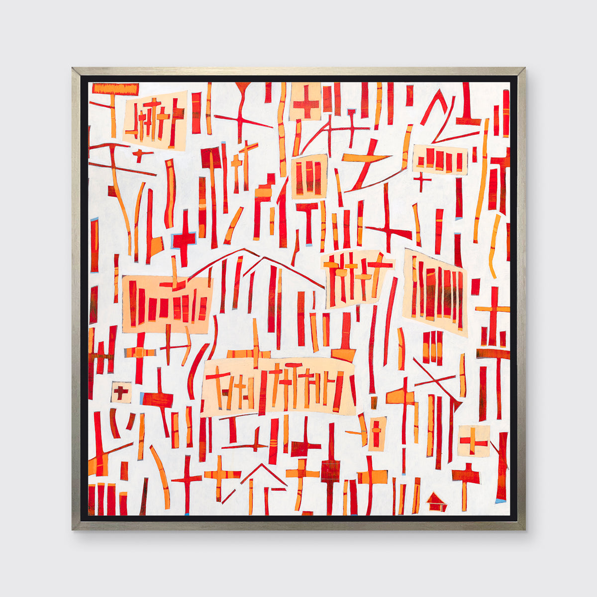 A red, orange and white abstract print in a silver floater frame hangs on a white wall.