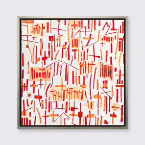 A red, orange and white abstract print in a silver floater frame hangs on a white wall.