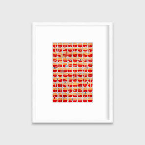 A red, orange and light blue abstract print in a white frame with a mat hangs on a white wall.