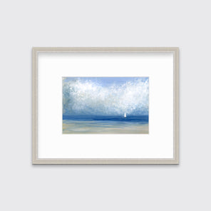 A blue, white and beige abstract seascape print in a silver frame with a mat hangs on a white wall.