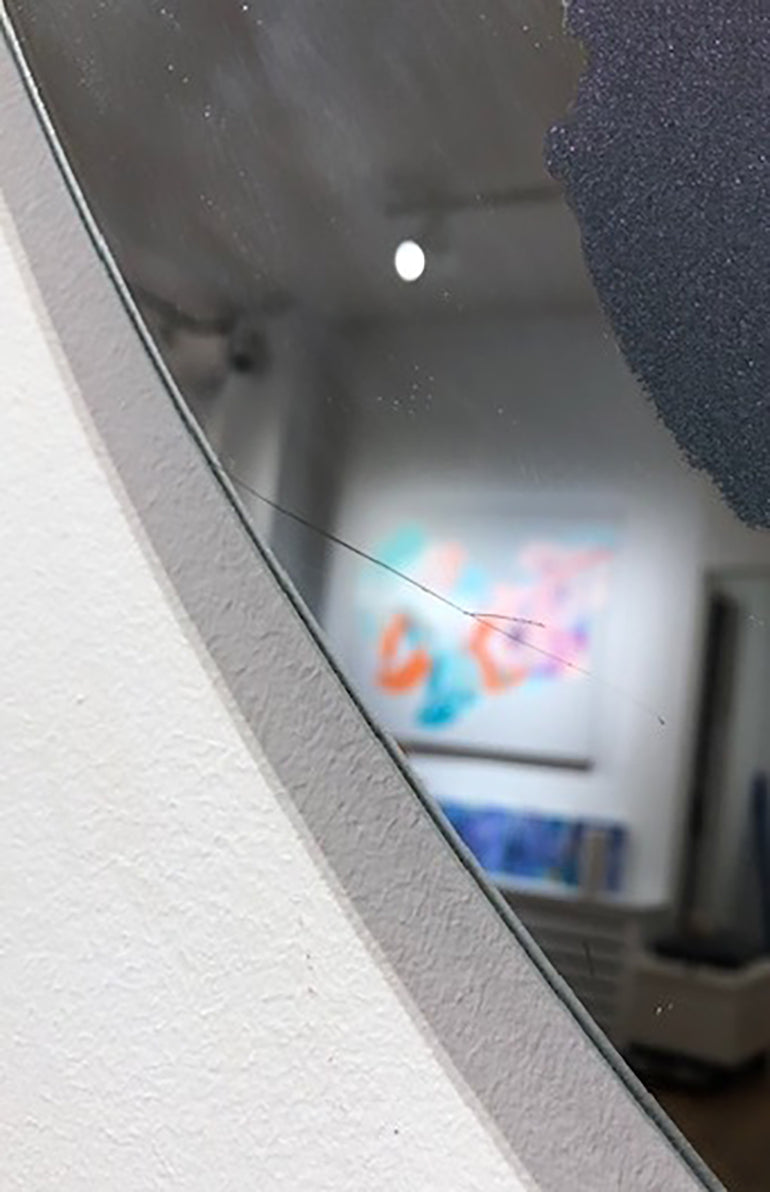 Detailed, close up of scratch mark on mirror. 