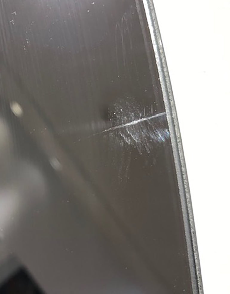 Detailed, close up of crack mark on mirror.