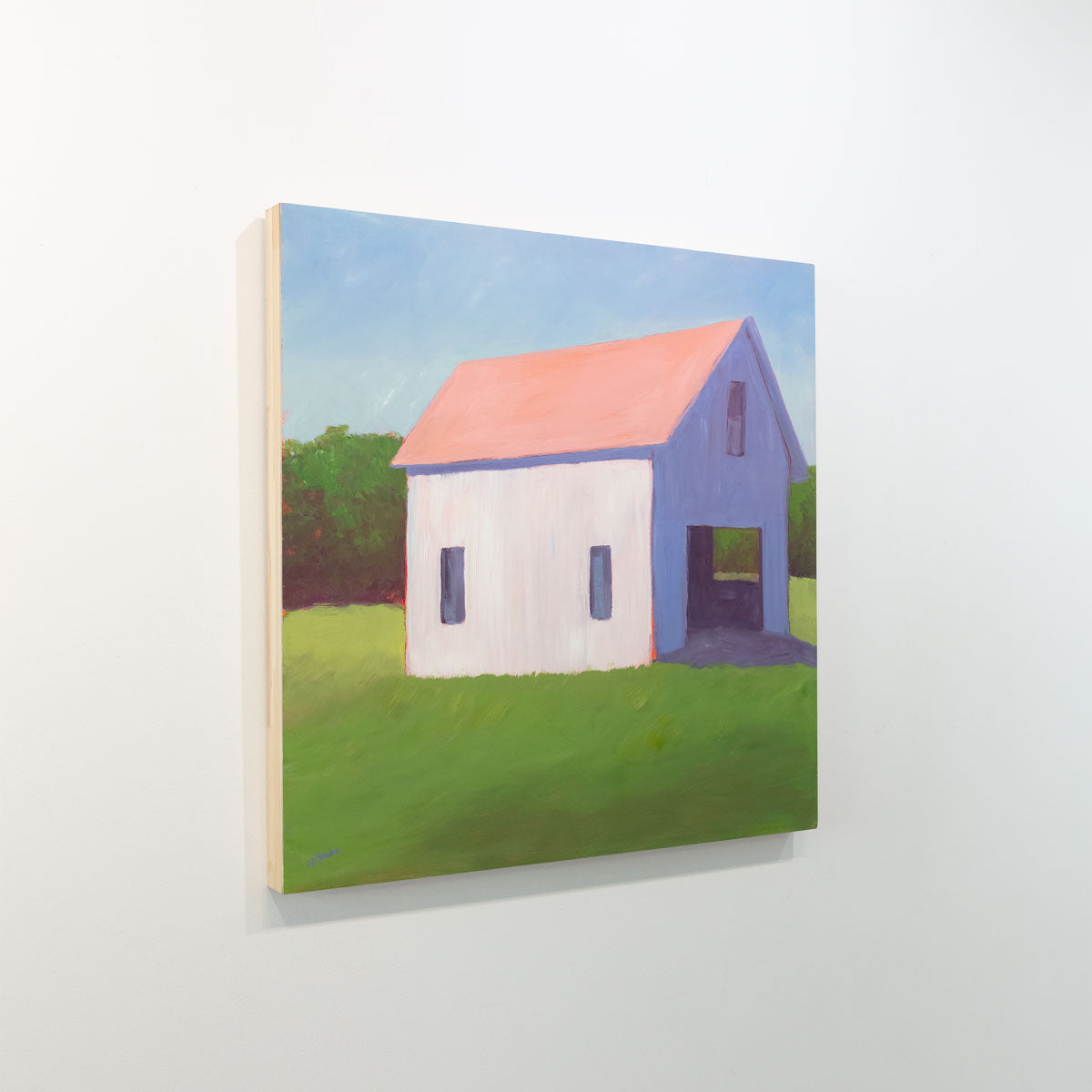 A painting of a white barn with a salmon roof in a green field with a pale blue sky background is seen at an angle on a gallery wall.