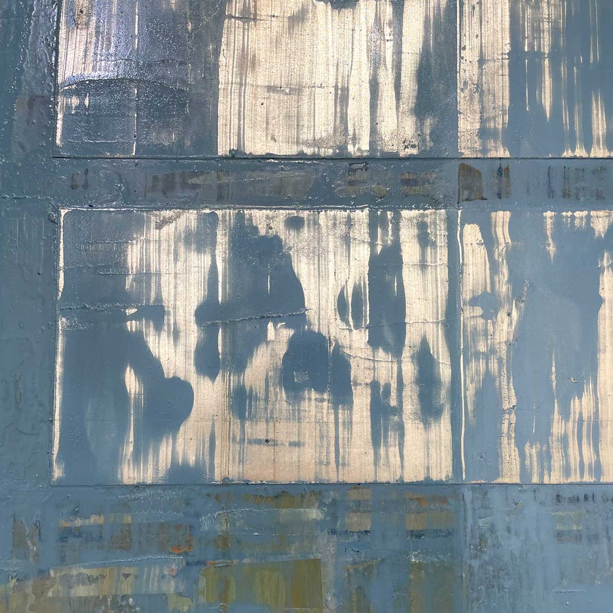 A close up detail image of the small aluminum panels applied to the board with a blue wash from an abstract painting by Ned Martin. 