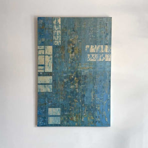 Mixed media abstract painting with small panels of aluminum and blue wash by Ned Martin hangs on a white wall with a view from straight on. 