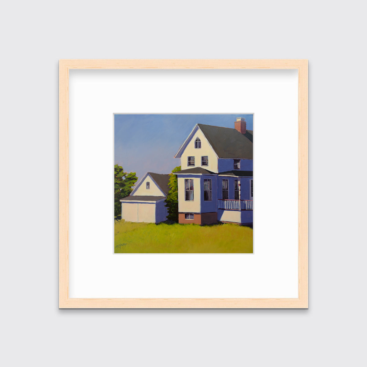 A blue, white and green contemporary house print in a natural wood frame with a mat hangs on a white wall.