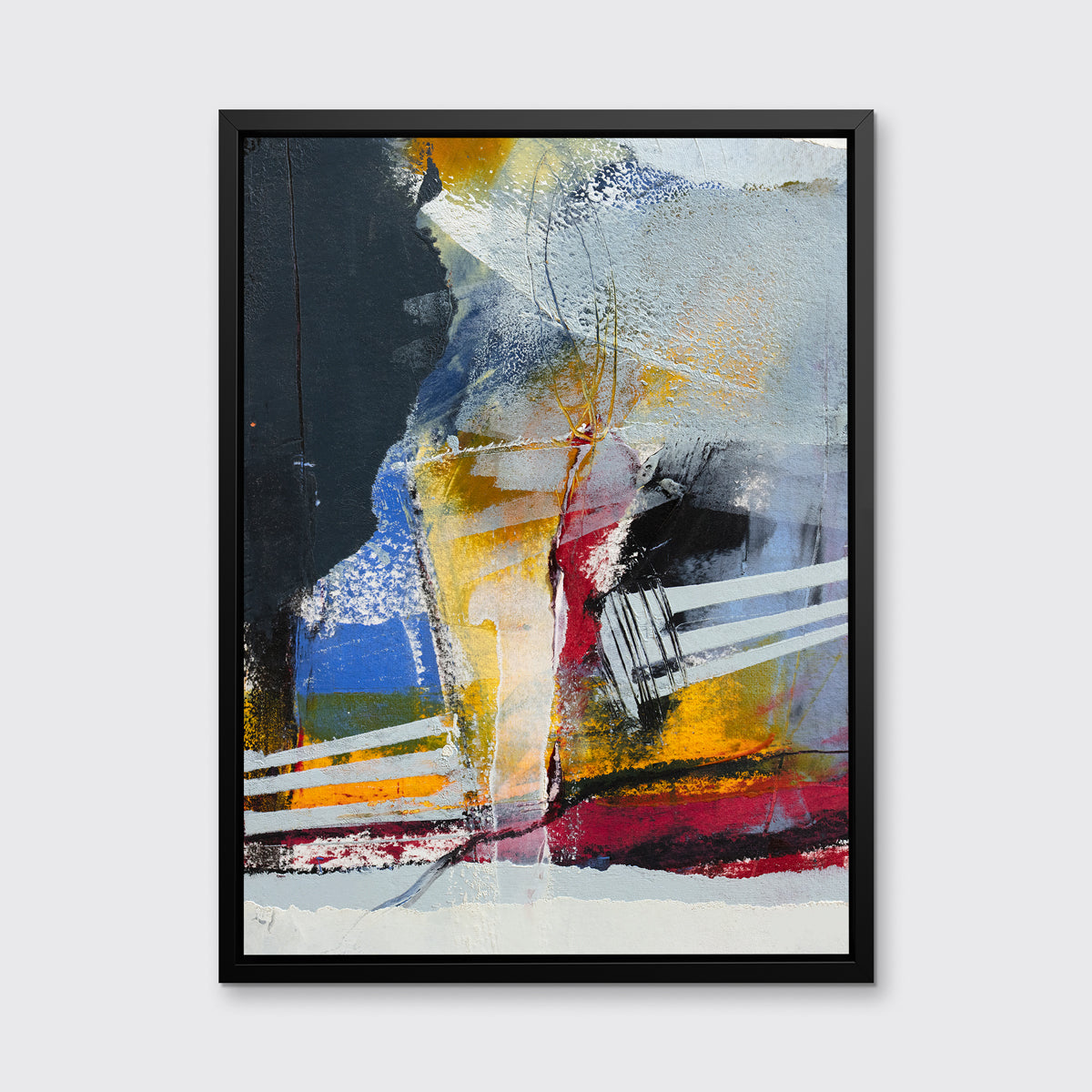 A white, yellow, red and grey abstract print in a black floater frame hangs on a white wall.